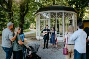 Children and adults alike are charmed by entertainers performing next to the Hellbrunn Gazebo, a place that captivates with its history and brings joy with its music.