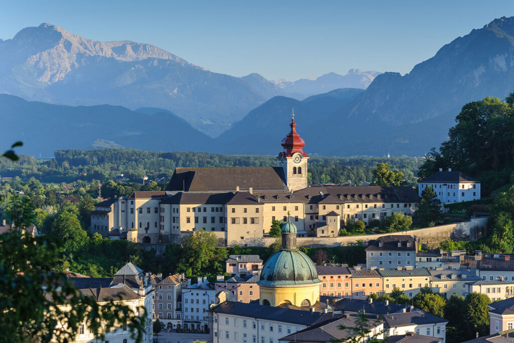 Overlooking a lush panorama, Nonnberg Abbey stands time-honored against the backdrop of the Austrian Alps, a highlight on the "Private Sound of Maria Tour" by weTours Salzburg.